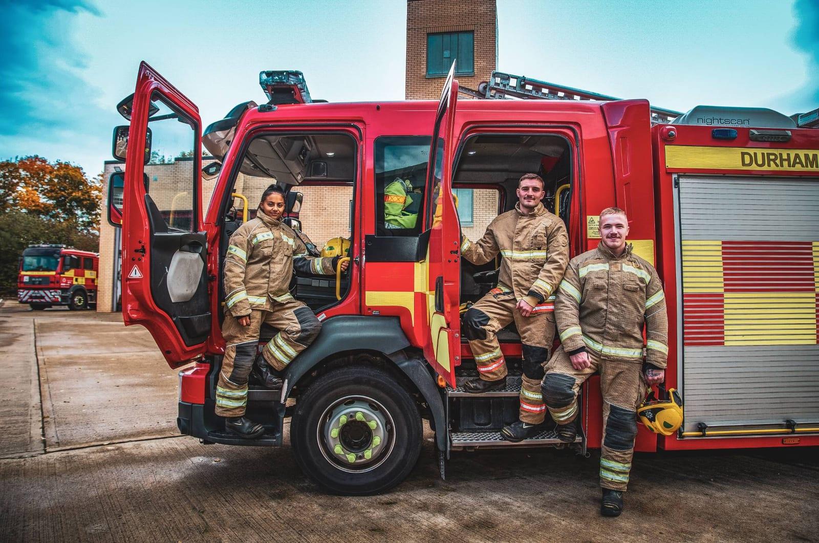 Durham firefighters posing with their fire engine